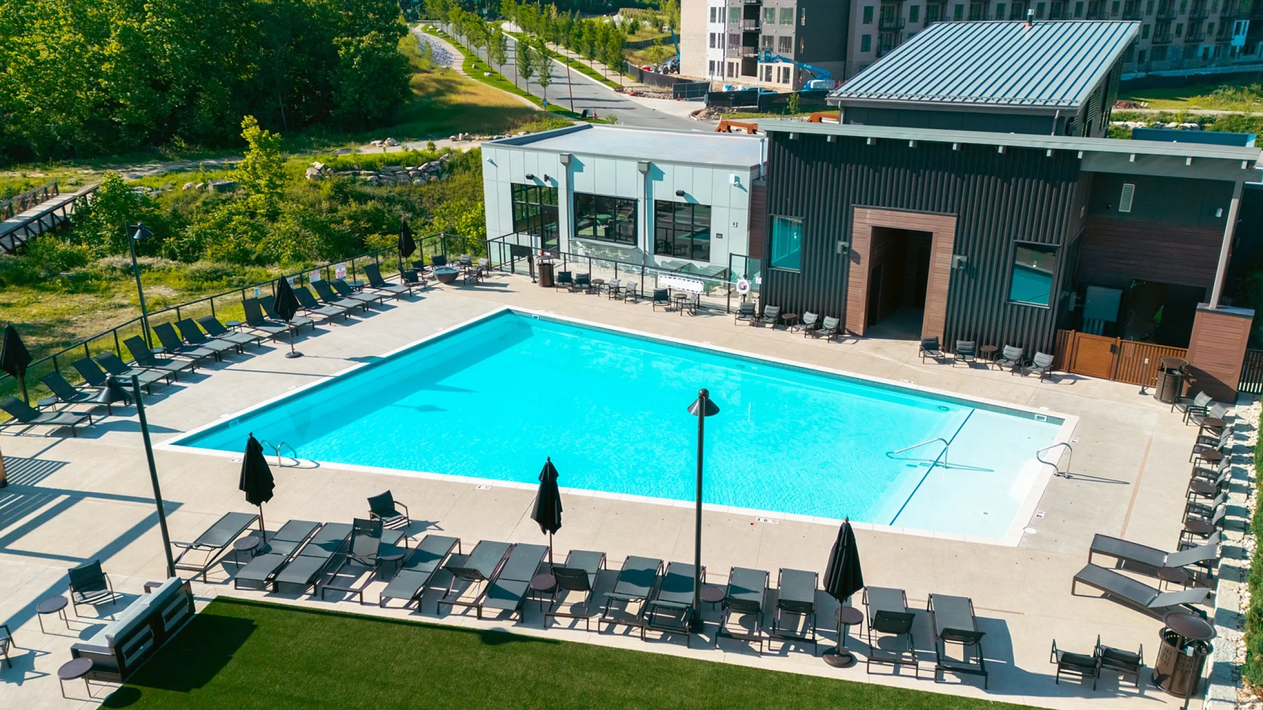 Inviting outdoor pool area surrounded by sun loungers and modern architecture.