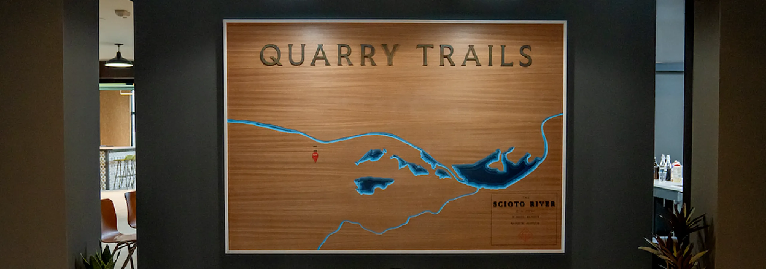 Stylish indoor display featuring a Quarry Trails map and modern lighting.