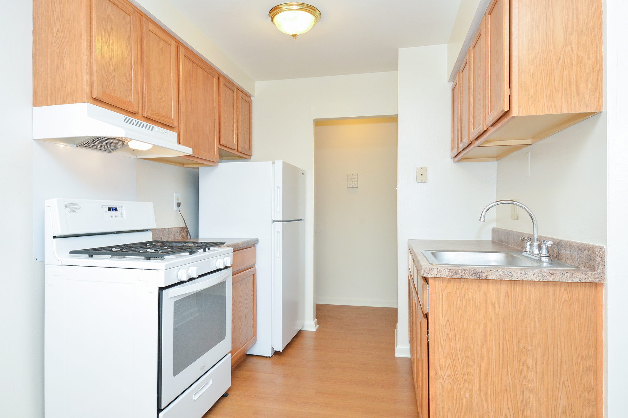 Newport Village Sample Kitchen with Brown Countertops and White Appliances | Levittown PA Apartments