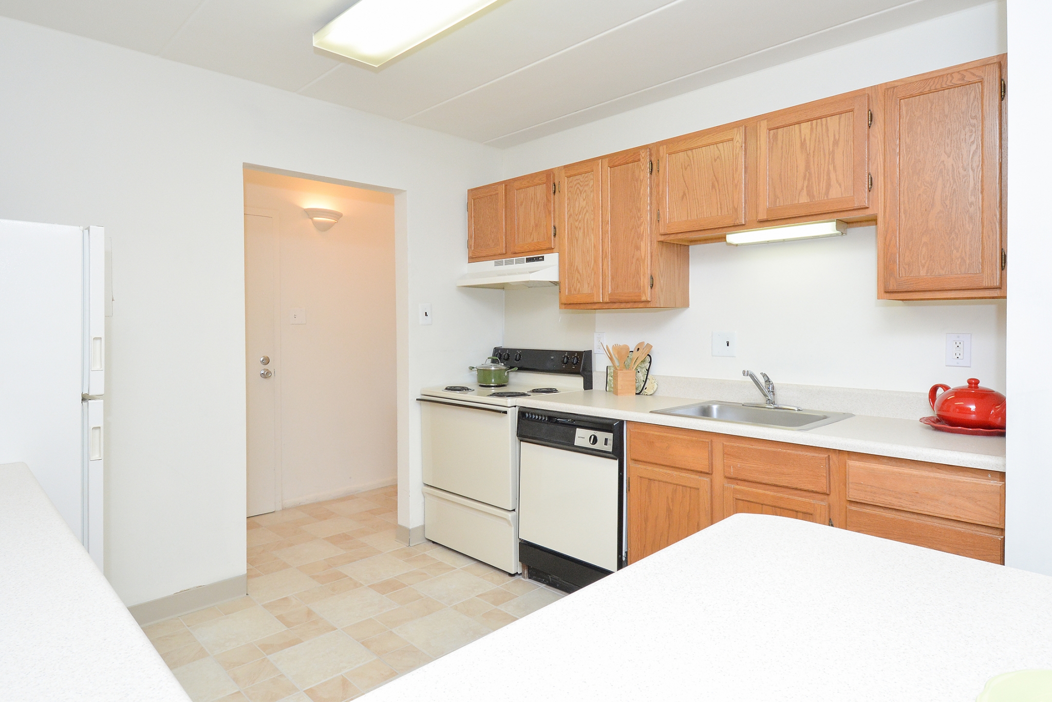 Fairway Park Sample Kitchen with Brown Cabinets and White Appliances | Apartments Near Wilmington DE