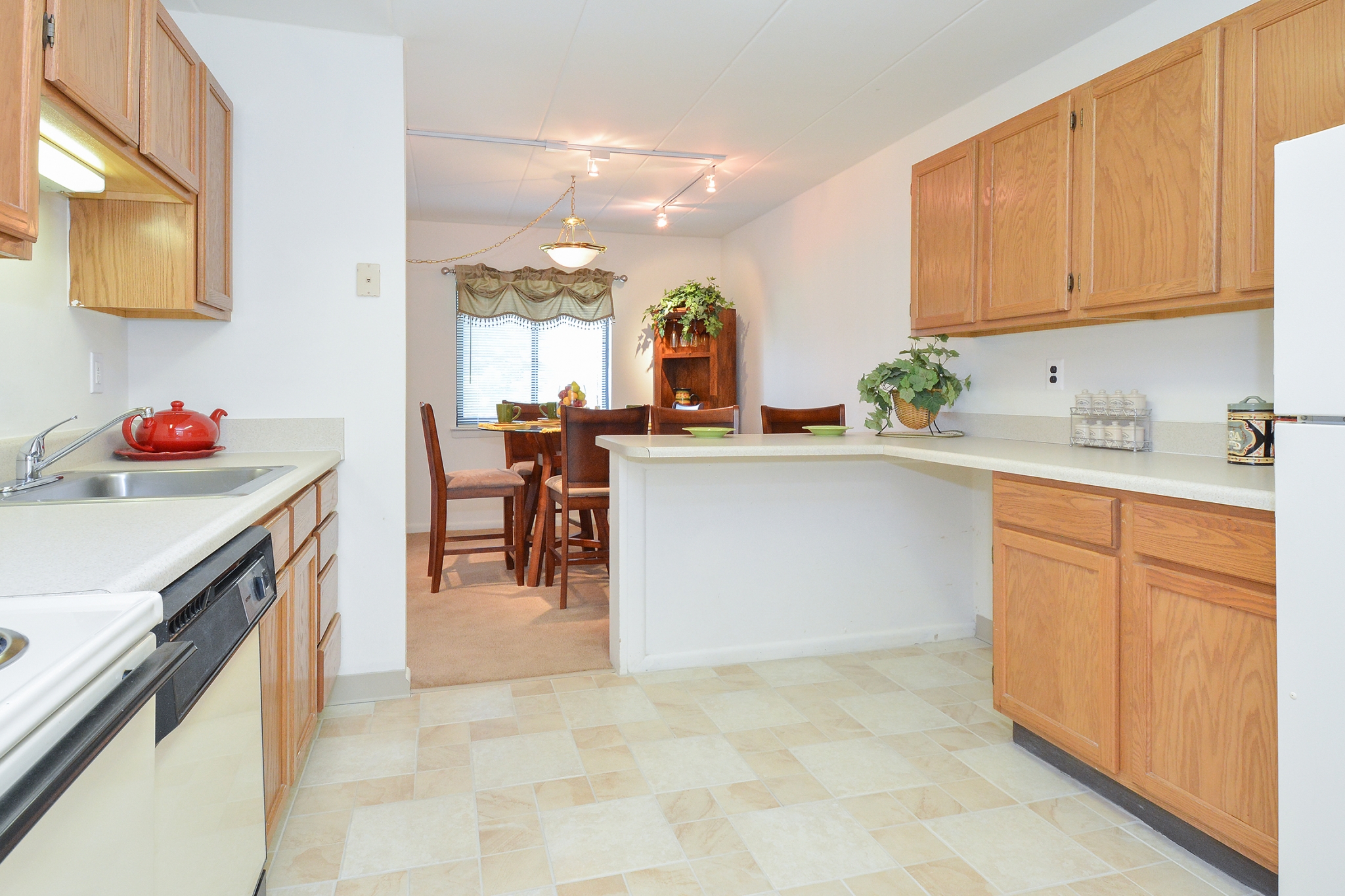 Fairway Park Sample Kitchen with Brown Cabinets and Tiled Floor | Apartments Near Wilmington DE