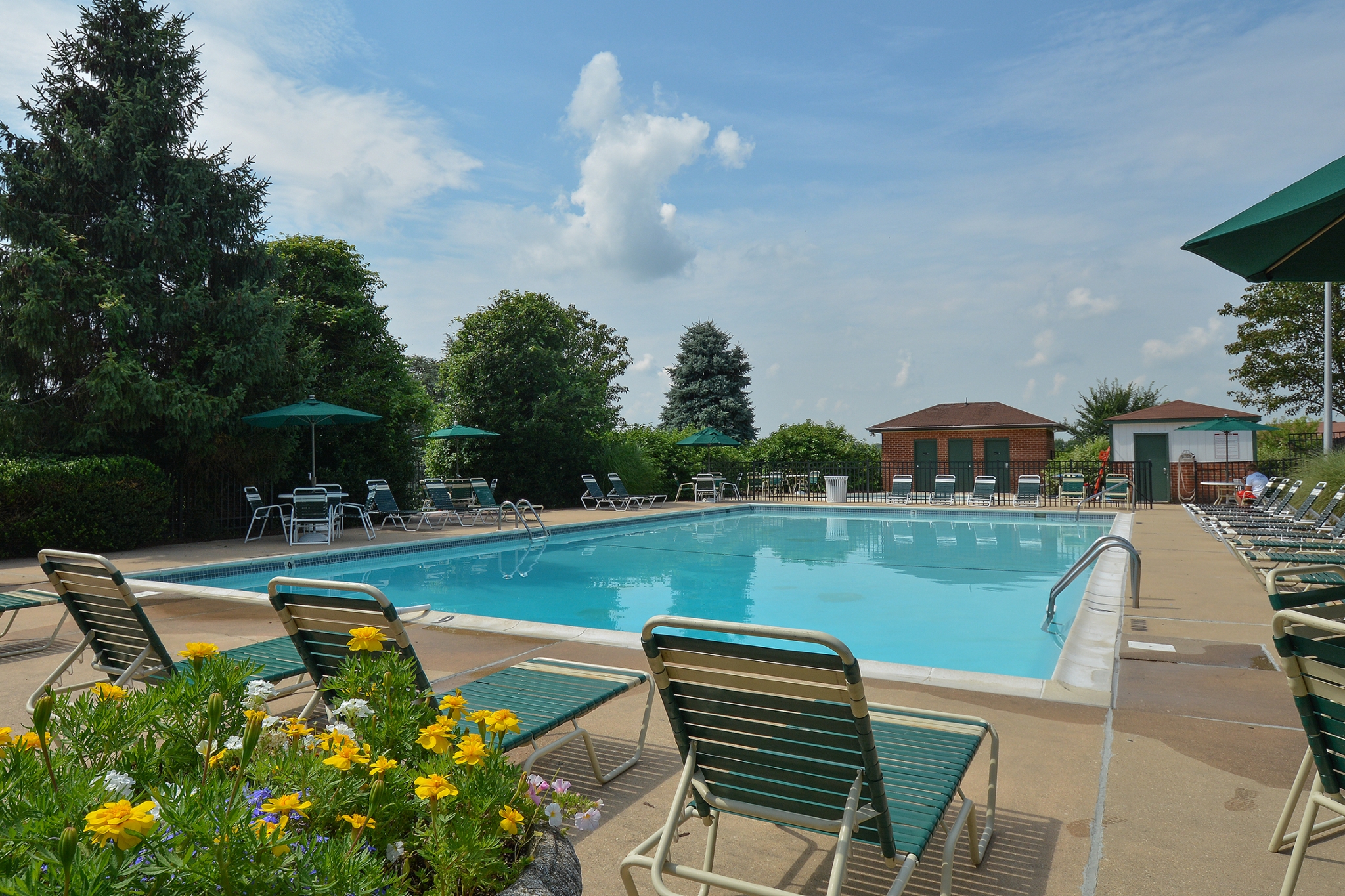 Fairway Park Swimming Pool with Chairs and Yellow Flowers | Apartments Near Wilmington DE