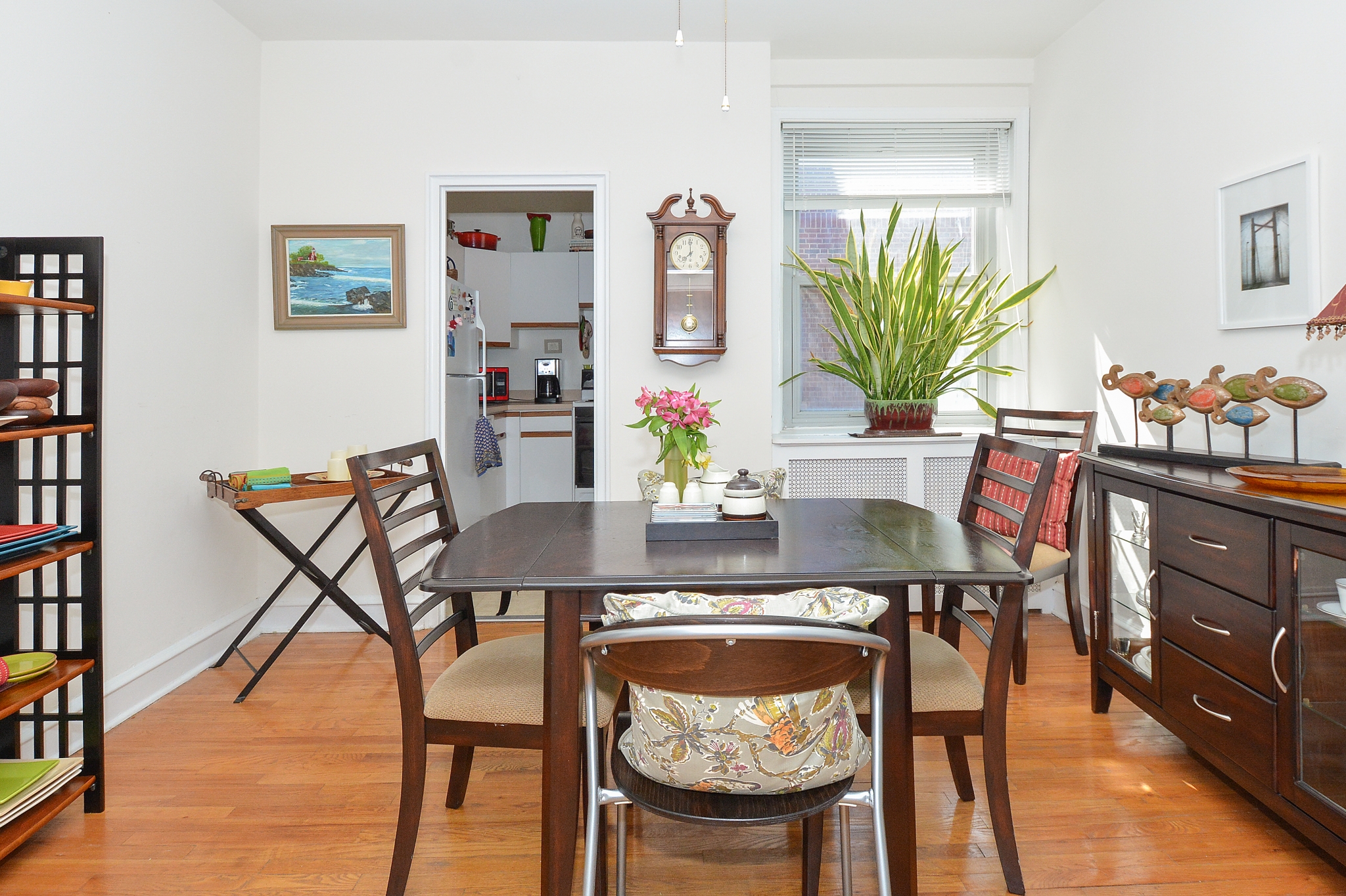 Gilpin Place Sample Dining Room with Kitchen View and Window with Plant | Apartments Near Wilmington DE