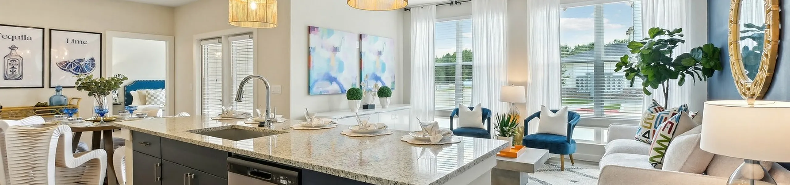 Modern open-concept living space with a stylish kitchen island, elegant dining area, and cozy living room featuring natural light.