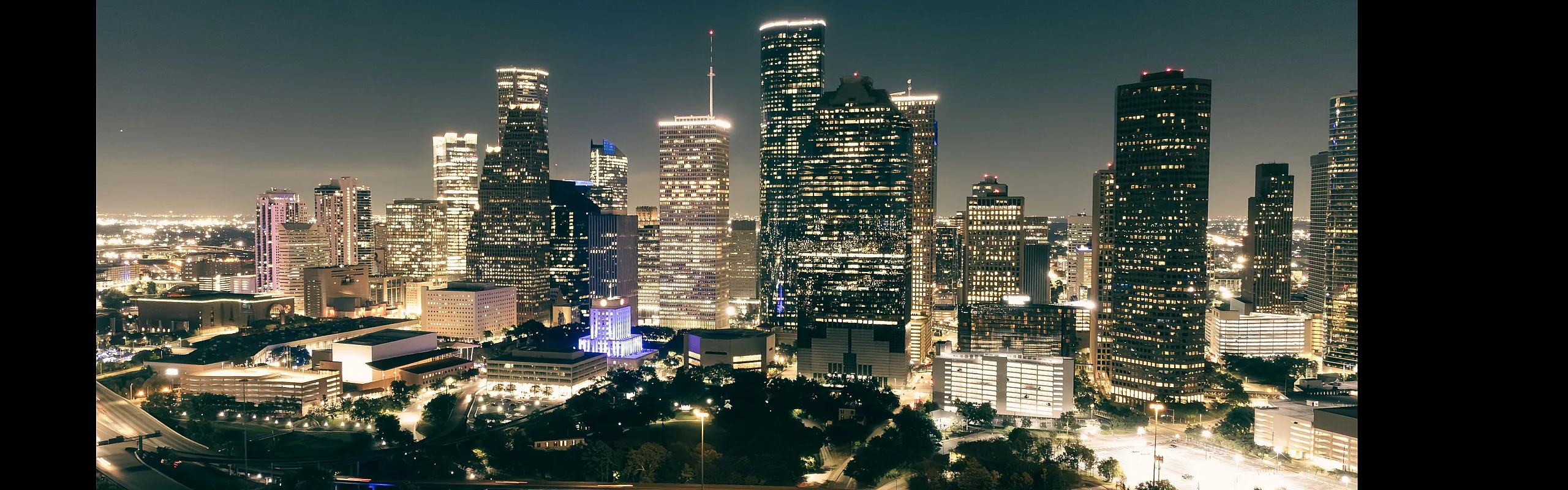 Breathtaking night view of a vibrant Houston skyline illuminated with sparkling lights and soaring skyscrapers.