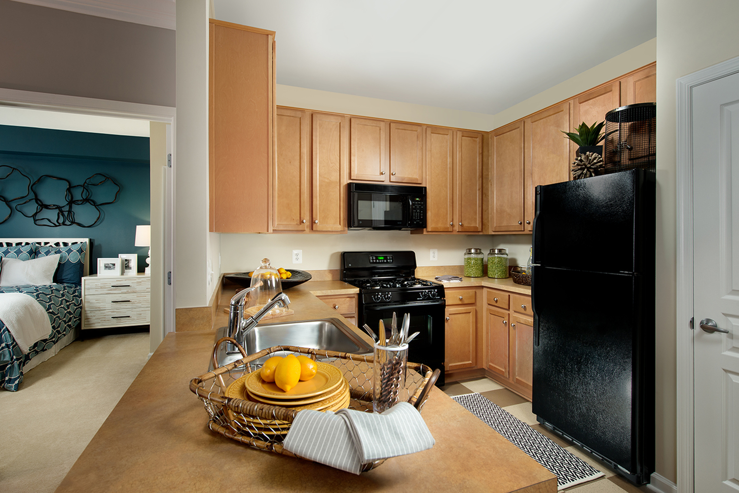 Modern kitchen adjacent to living room and large bedroom