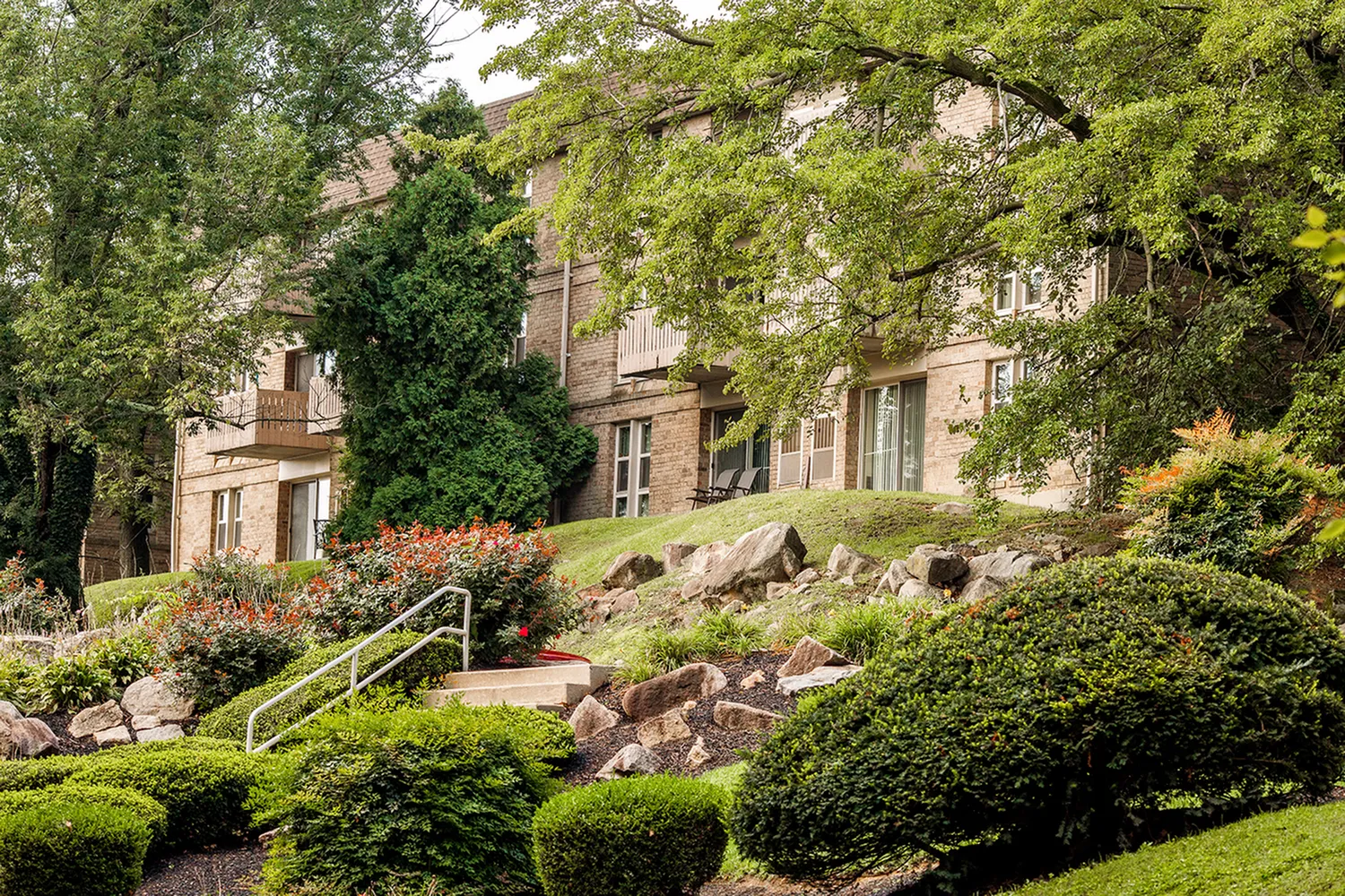 Exterior view of apartment surrounded by trees
