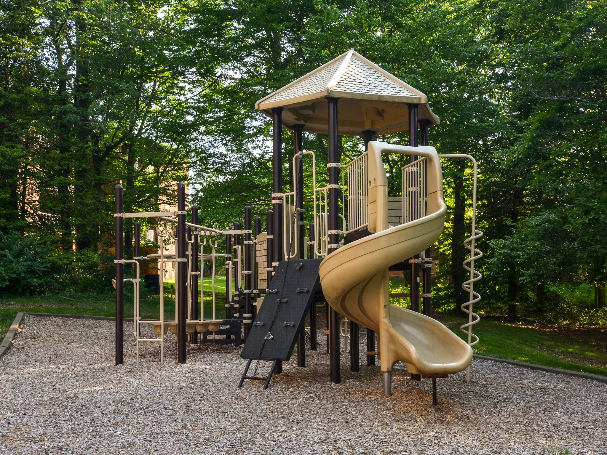Children's playground with slide and climbing equipment.