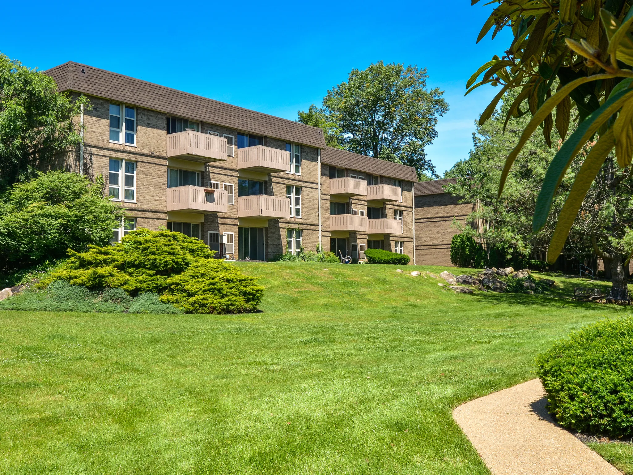 Street view of apartments with balconies and trees