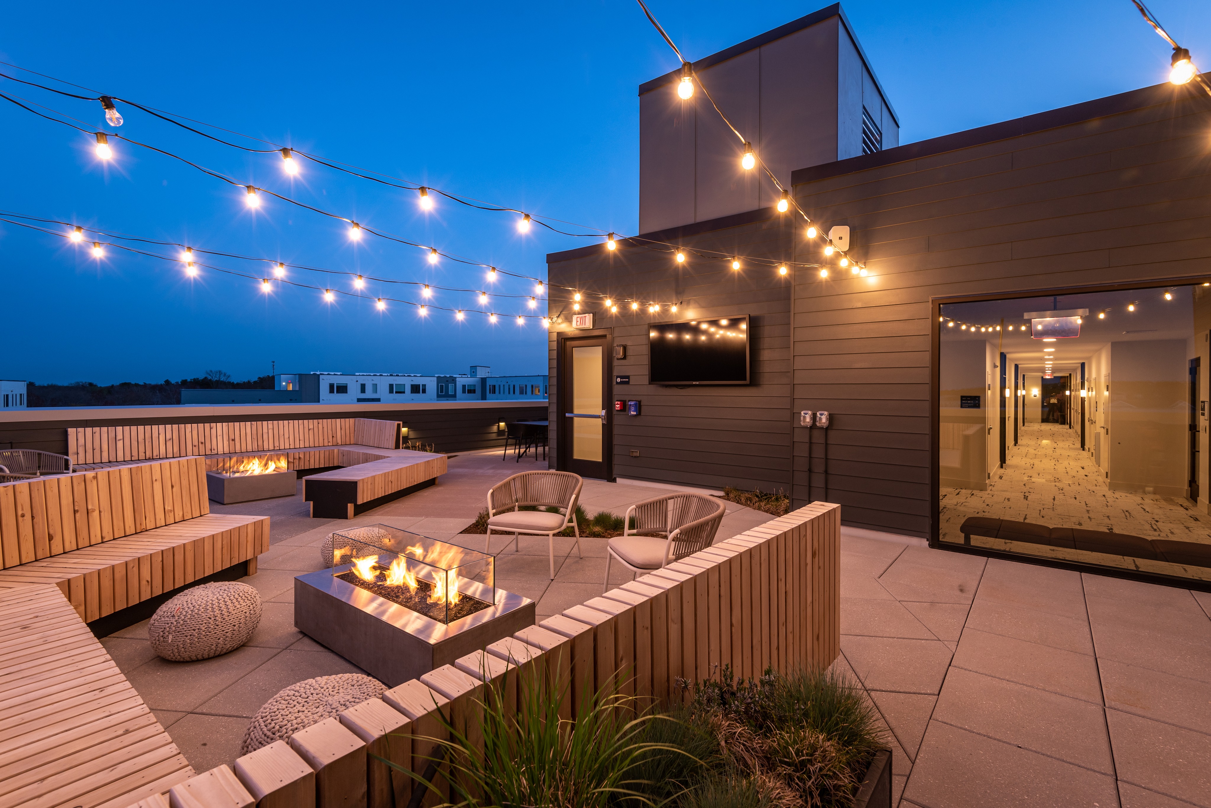 Adjoining roof deck with fire pit & lounge seating