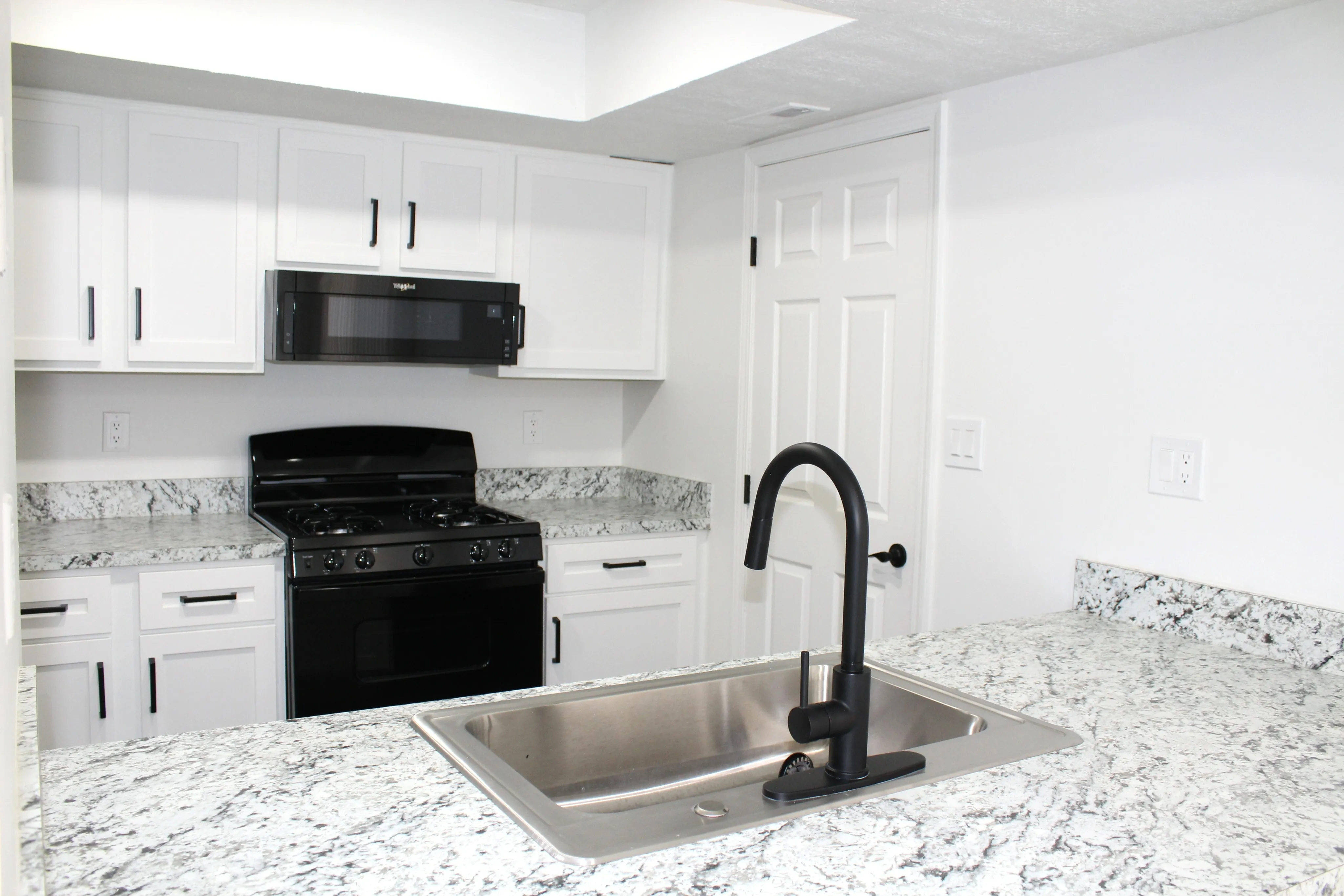 Kitchen - countertops, sink, cabinetry, stove, microwave  | The Residence at Turnberry | Columbus Apartments