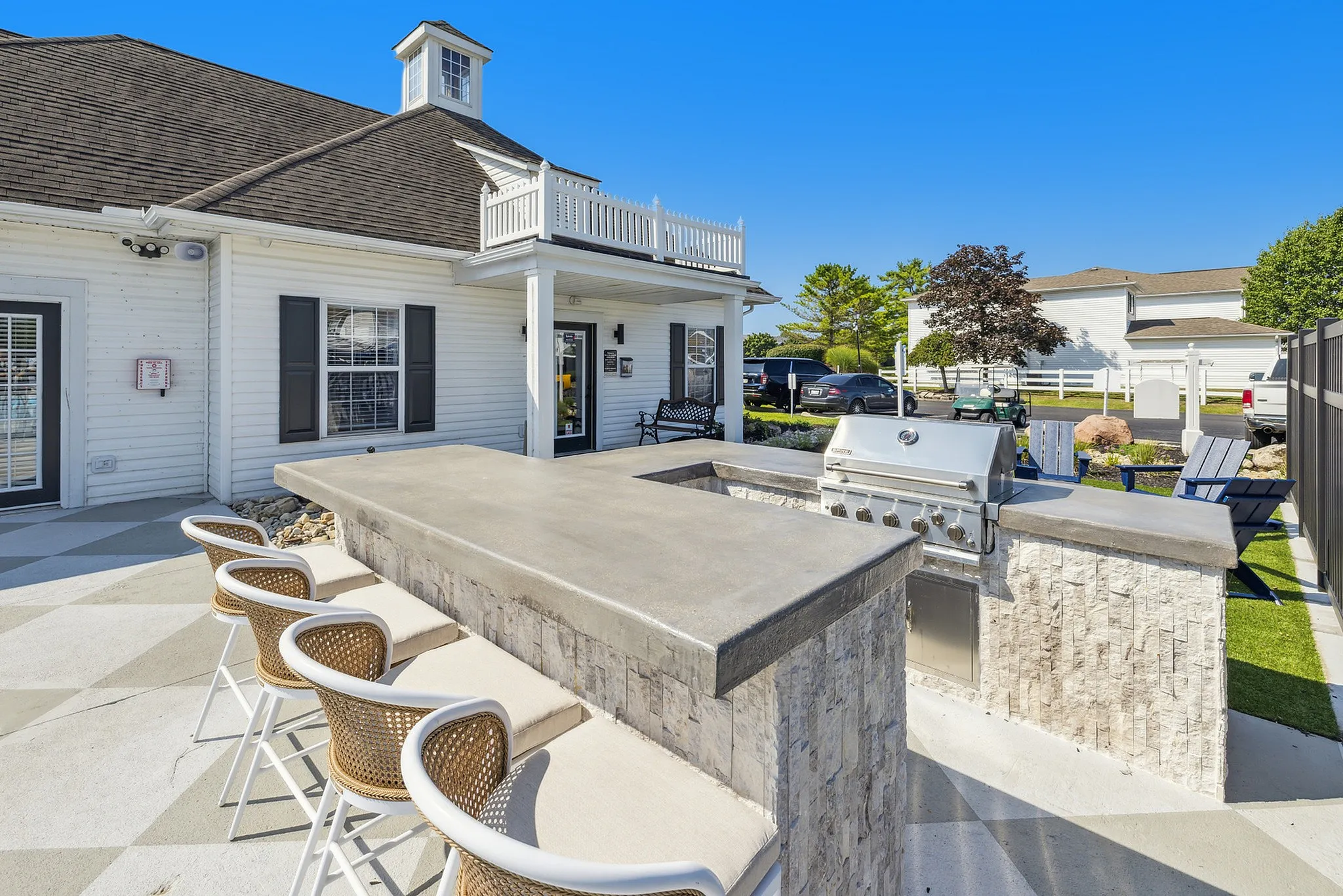 Charming outdoor patio with a modern barbecue area, stylish seating, and a scenic garden view, perfect for entertaining.