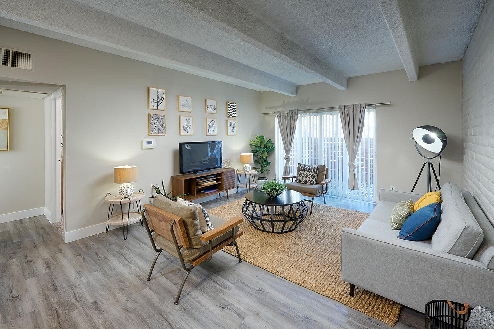 Chic living room with modern furnishings, bright natural light, and stylish decor, perfect for entertaining.