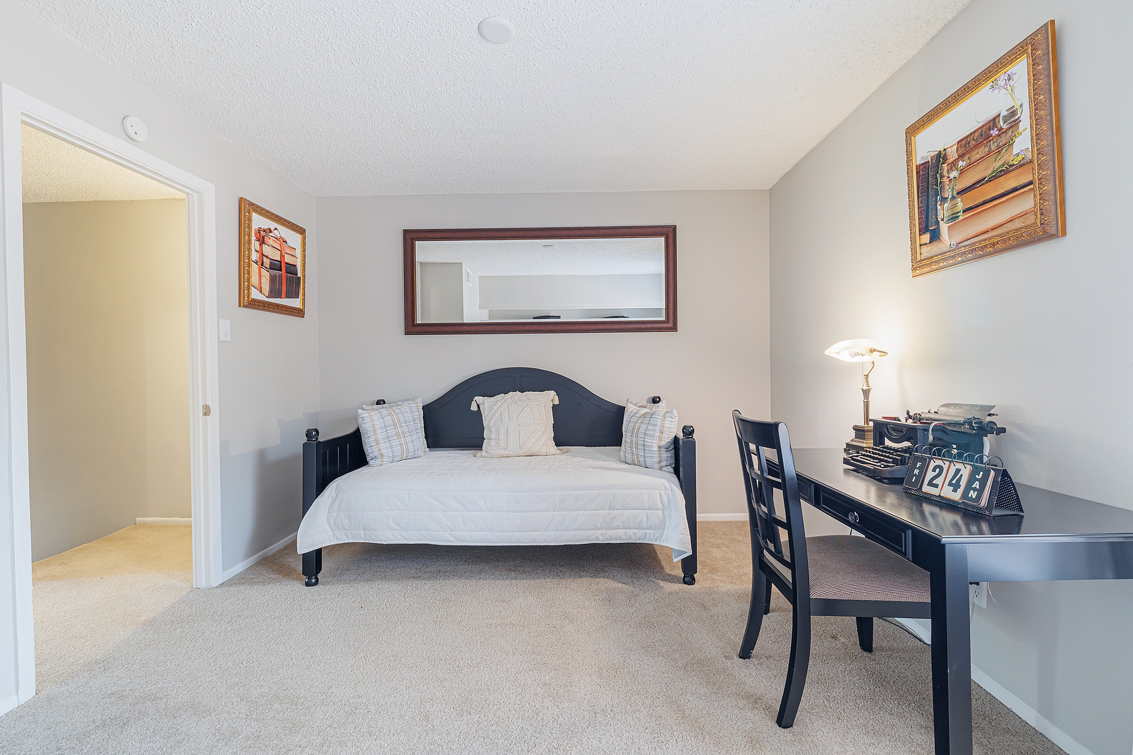 Cozy home office space with a chic daybed, elegant desk, and stylish decor, ideal for productivity and relaxation.