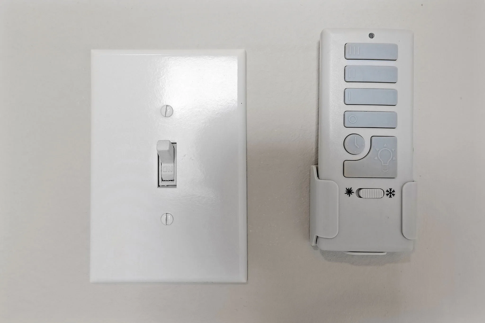 Modern light switch and remote panel offering convenient control and sleek design for contemporary living spaces.