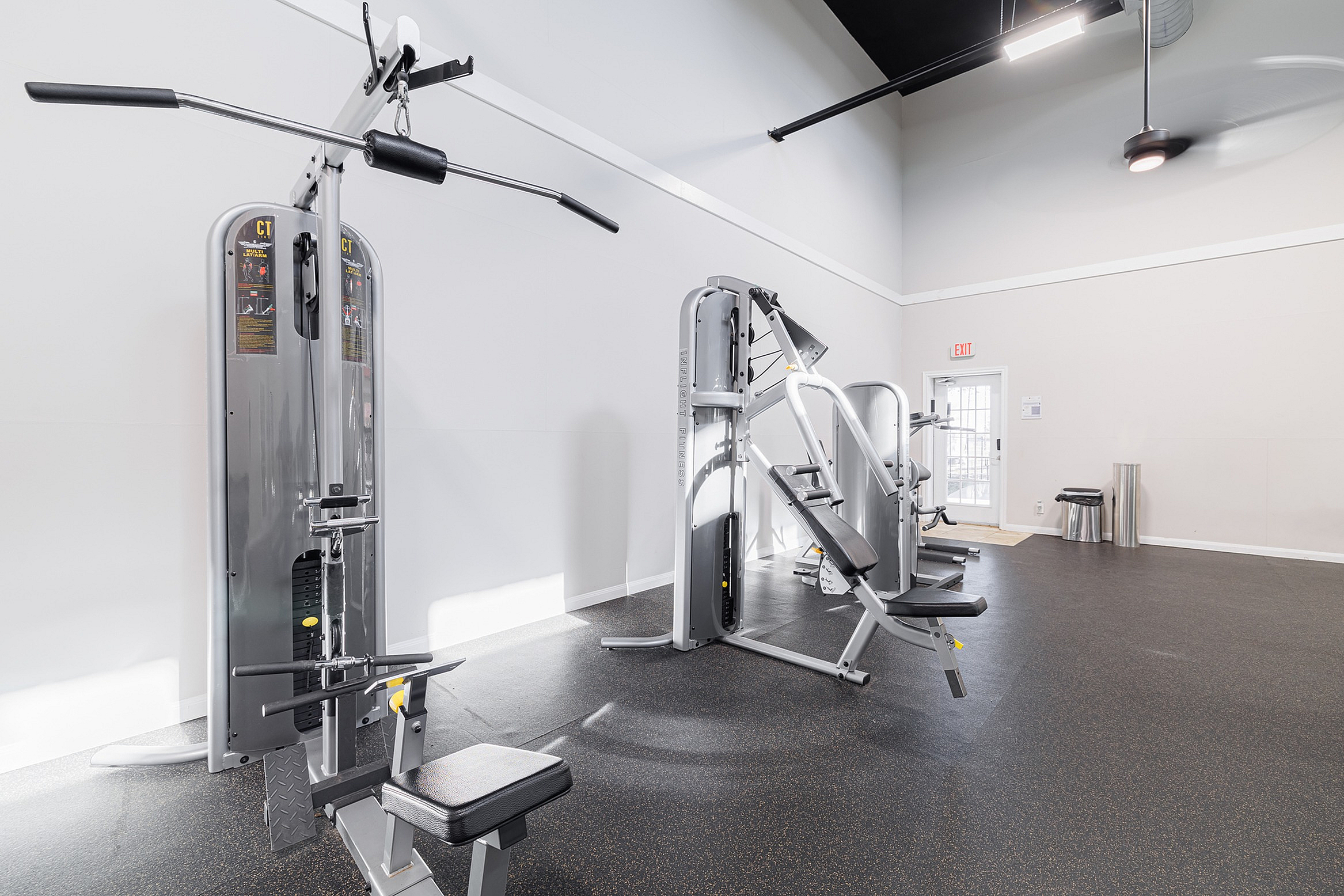 Bright and modern gym equipped with high-end workout machines and ample space for exercise.