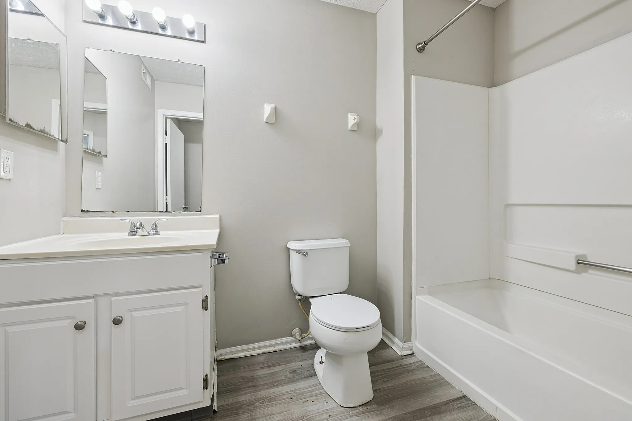 Modern bathroom showcasing sleek vanity, pristine bathtub, and elegant lighting, offering a clean and inviting space.