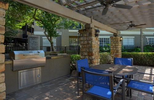 Grills & tables with seating at Villas at Hermann Park | Apartments | Houston, TX