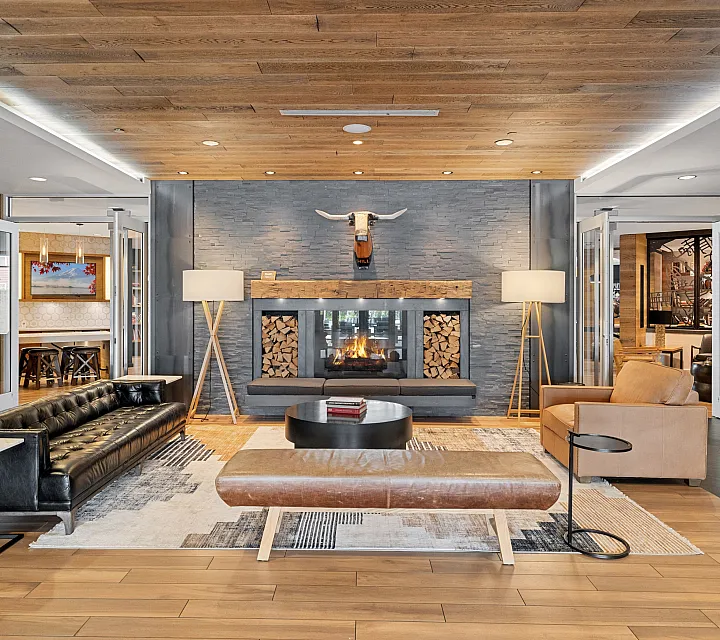 Luxurious living room with cozy fireplace, stylish leather seating, and elegant wooden paneling, creating a warm and inviting atmosphere.