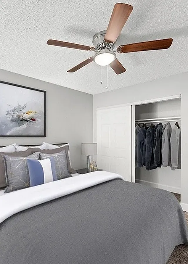 Inviting bedroom featuring a cozy bed with elegant pillows, stylish nightstands, and spacious closet space.