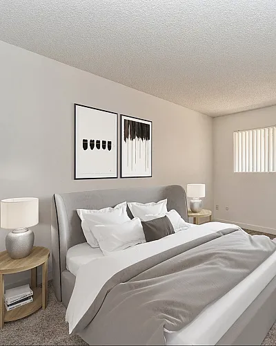 Bright and airy bedroom with stylish decor, featuring a comfortable bed, modern artwork, and an inviting reading nook.