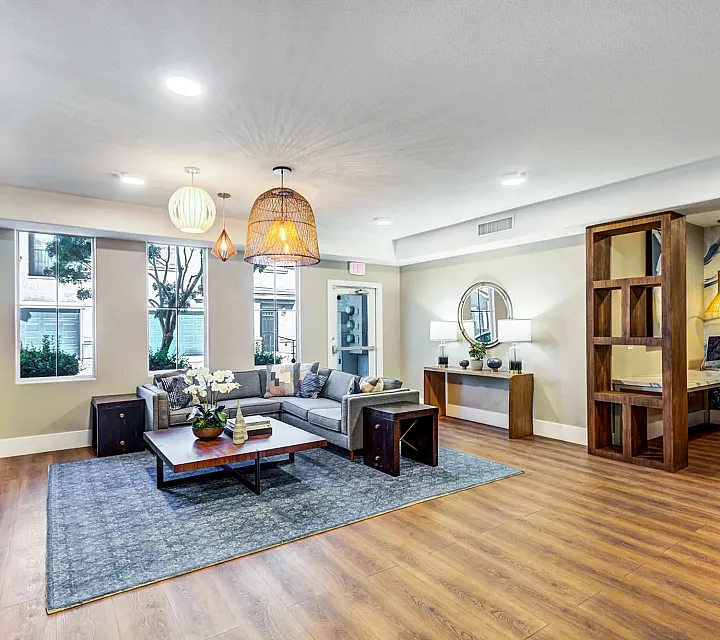 Modern apartment living room featuring elegant decor, natural lighting, and stylish wooden accents, perfect for a cozy and inviting atmosphere.