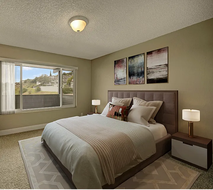 Elegant bedroom with a plush bed, modern decor, and a large window offering scenic hillside views.