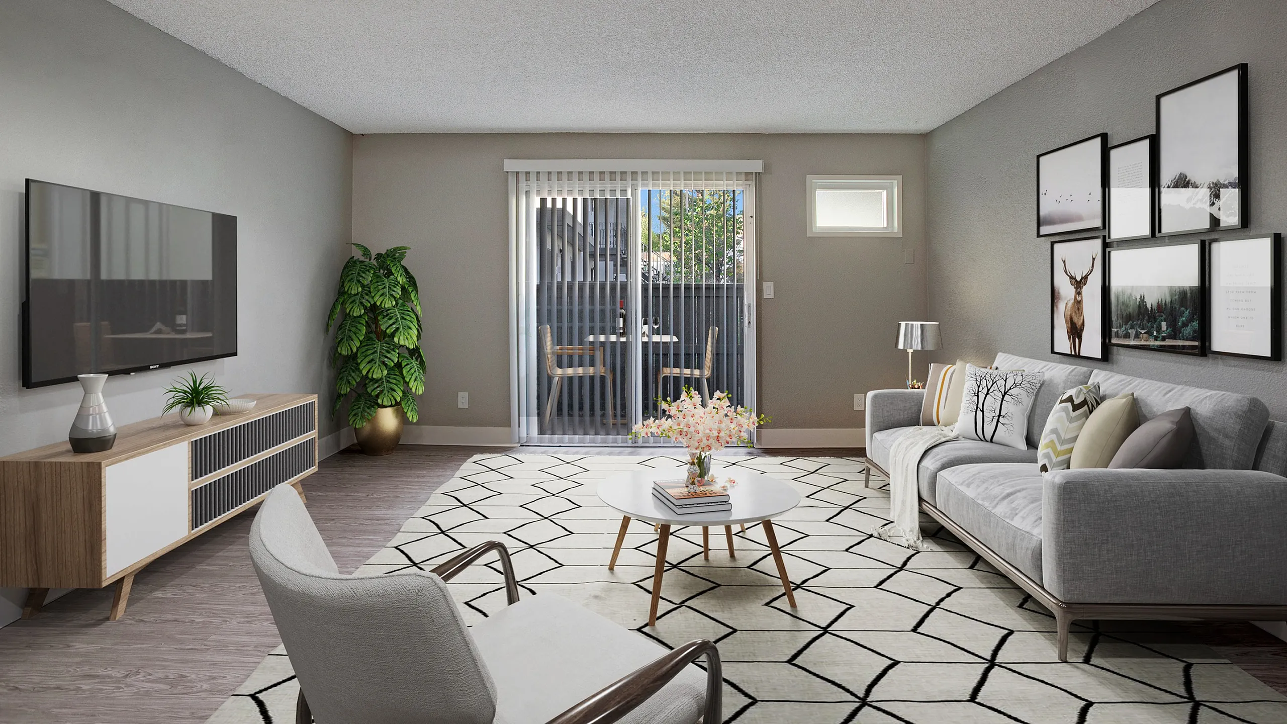 Contemporary living room with stylish gray sofa, modern decor, large TV, and inviting patio view.