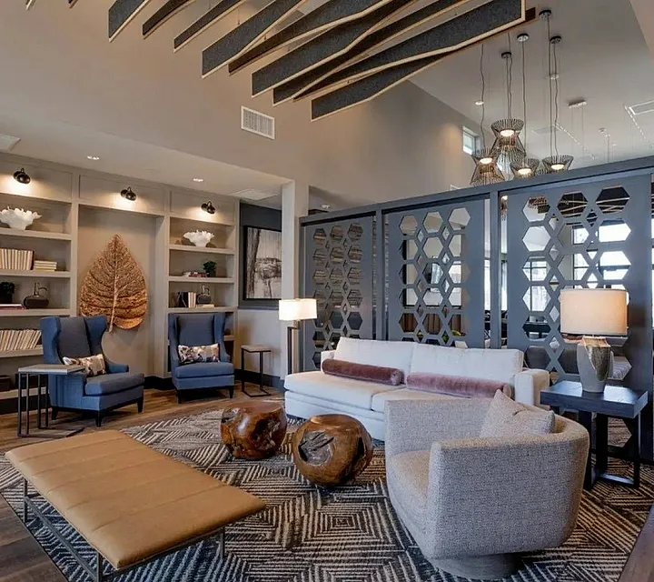 Luxurious lounge with elegant furniture, chic shelving, and stylish lighting, featuring modern decor and a warm, inviting ambiance.