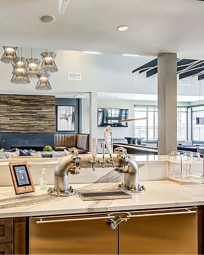 Elegant lounge area with modern lighting, stylish marble countertops, and a cozy fireplace, perfect for relaxation and entertainment.