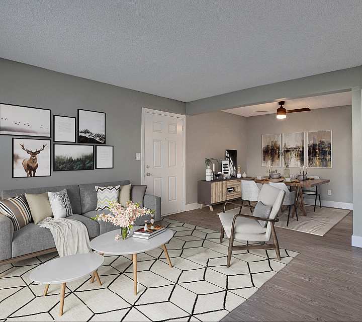 Elegant open-plan living space with modern decor, featuring a cozy seating area, stylish dining setup, and sleek kitchen with contemporary barstools.