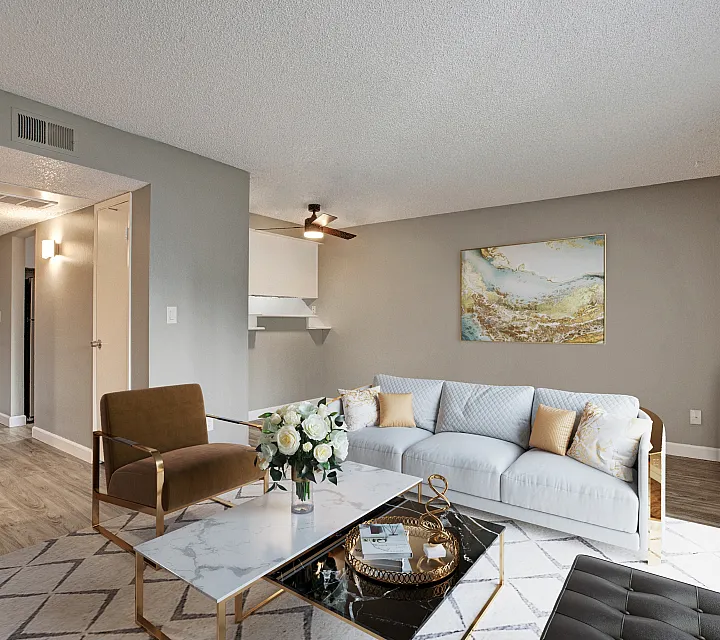 Modern living room with elegant furnishings, featuring a cozy sofa, stylish accent chair, and a chic coffee table adorned with fresh flowers.