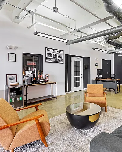 Modern and spacious loft with industrial design, featuring sleek furniture and exposed ductwork, creating a stylish and inviting atmosphere.