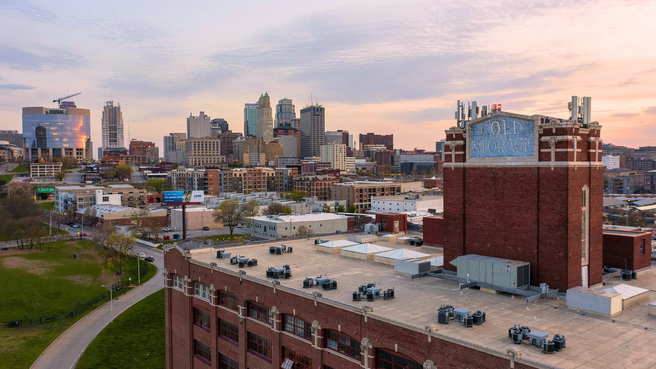 Captivating cityscape view from an apartment showcasing a charming blend of historic architecture and modern skyline at sunset.