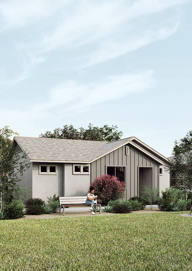 Charming row of modern homes surrounded by lush greenery, featuring cozy outdoor spaces and quaint benches, perfect for peaceful living.