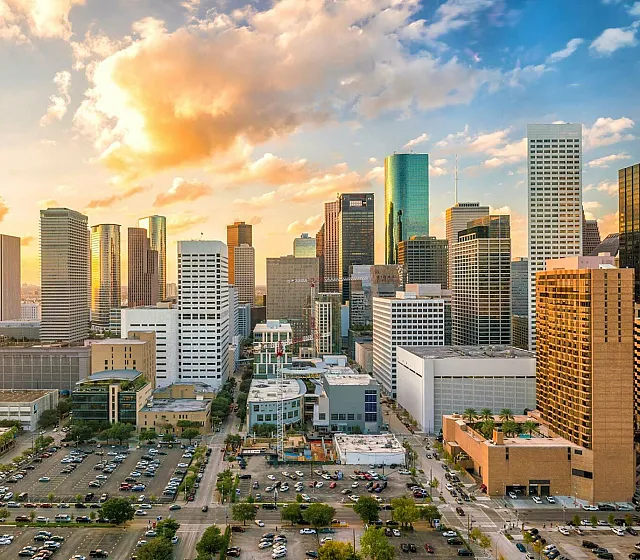 Breathtaking cityscape view at sunset, showcasing a vibrant skyline with towering buildings and colorful skies.