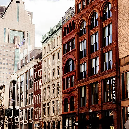 Charming street view showcasing an array of historic and modern architecture with elegant facades and lively urban atmosphere.