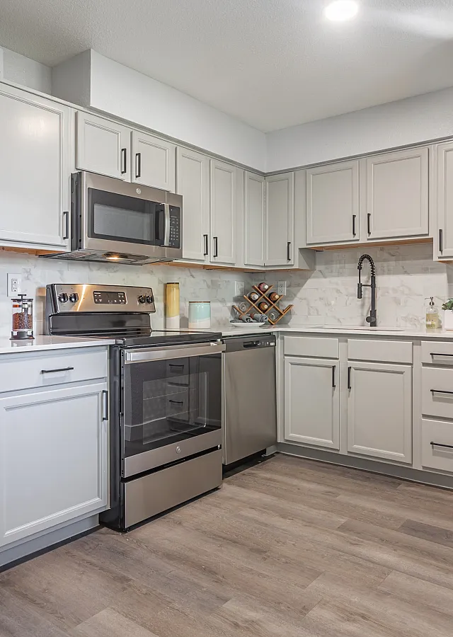 Modern kitchen with sleek stainless steel appliances, elegant cabinetry, and in-unit washer-dryer for convenience.