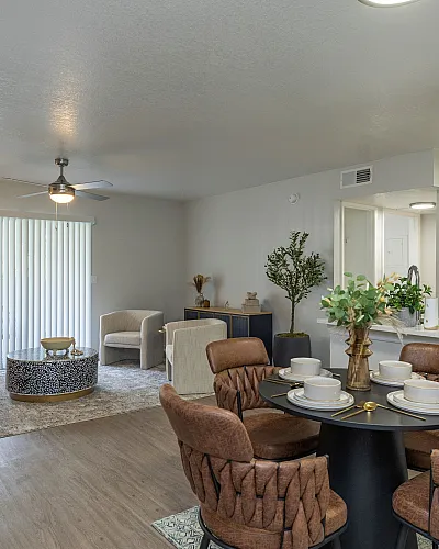 Chic open-concept living room with cozy seating, stylish dining area, and abundant natural light.