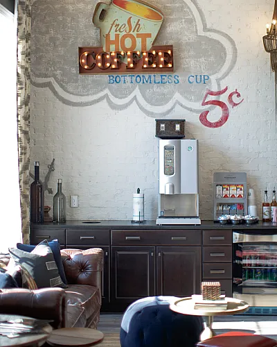 Chic coffee lounge with vintage decor, featuring a cozy setting, plush leather seating, and an inviting coffee station. Perfect for relaxation and social gatherings.