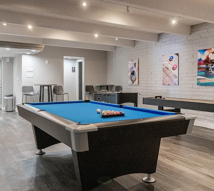 Chic game room with modern pool table, inviting seating area, and stylish decor, perfect for entertainment.