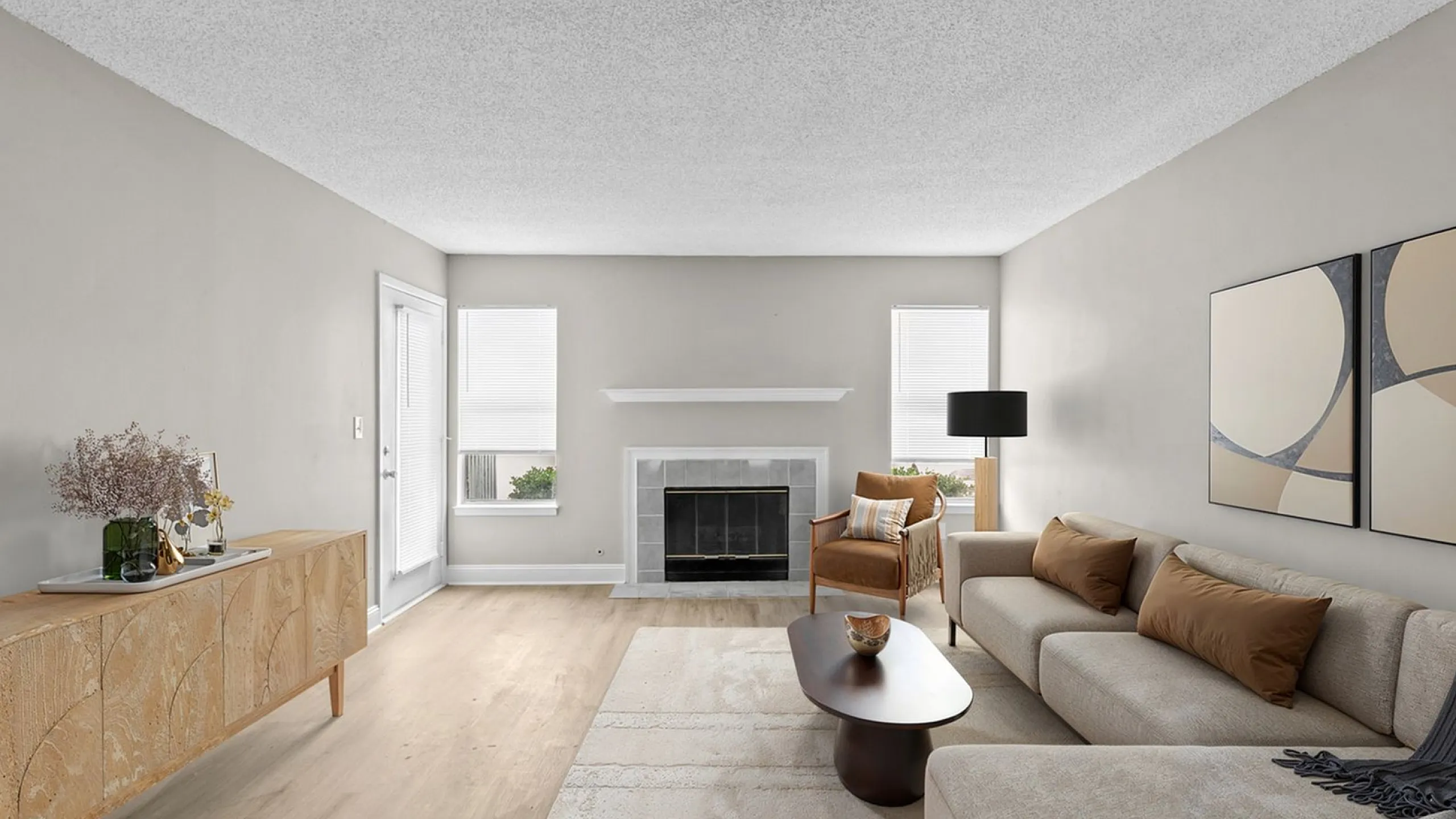 Elegant living room with modern decor, featuring a cozy fireplace, stylish furniture, and abundant natural light.