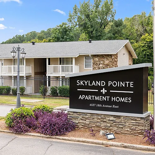 Charming Skyland Pointe apartment community with lush greenery and modern architecture on 18th Avenue East.