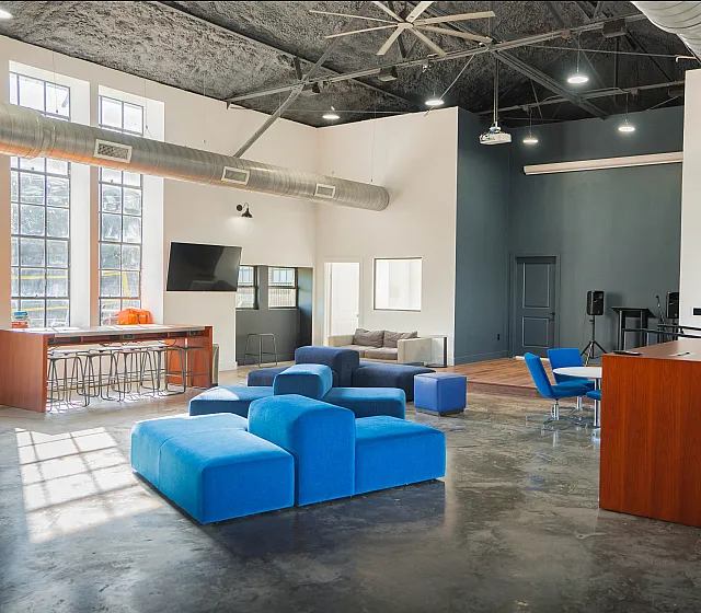 Spacious loft with modern furnishings, high ceilings, and industrial design elements.
