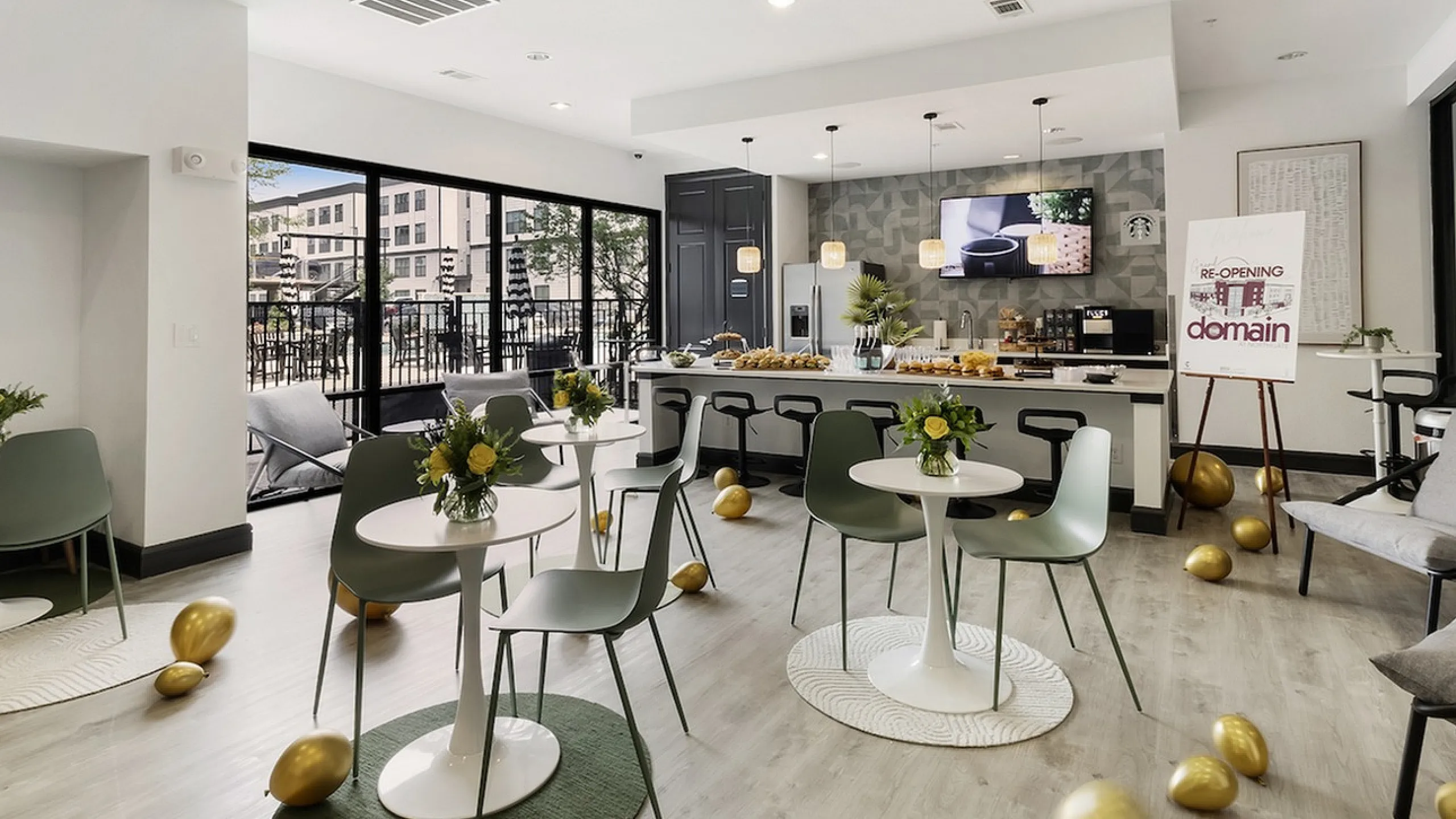 Elegant communal area with modern decor, showcasing a bright lounge with stylish dining setups and a chic breakfast bar for social gatherings.