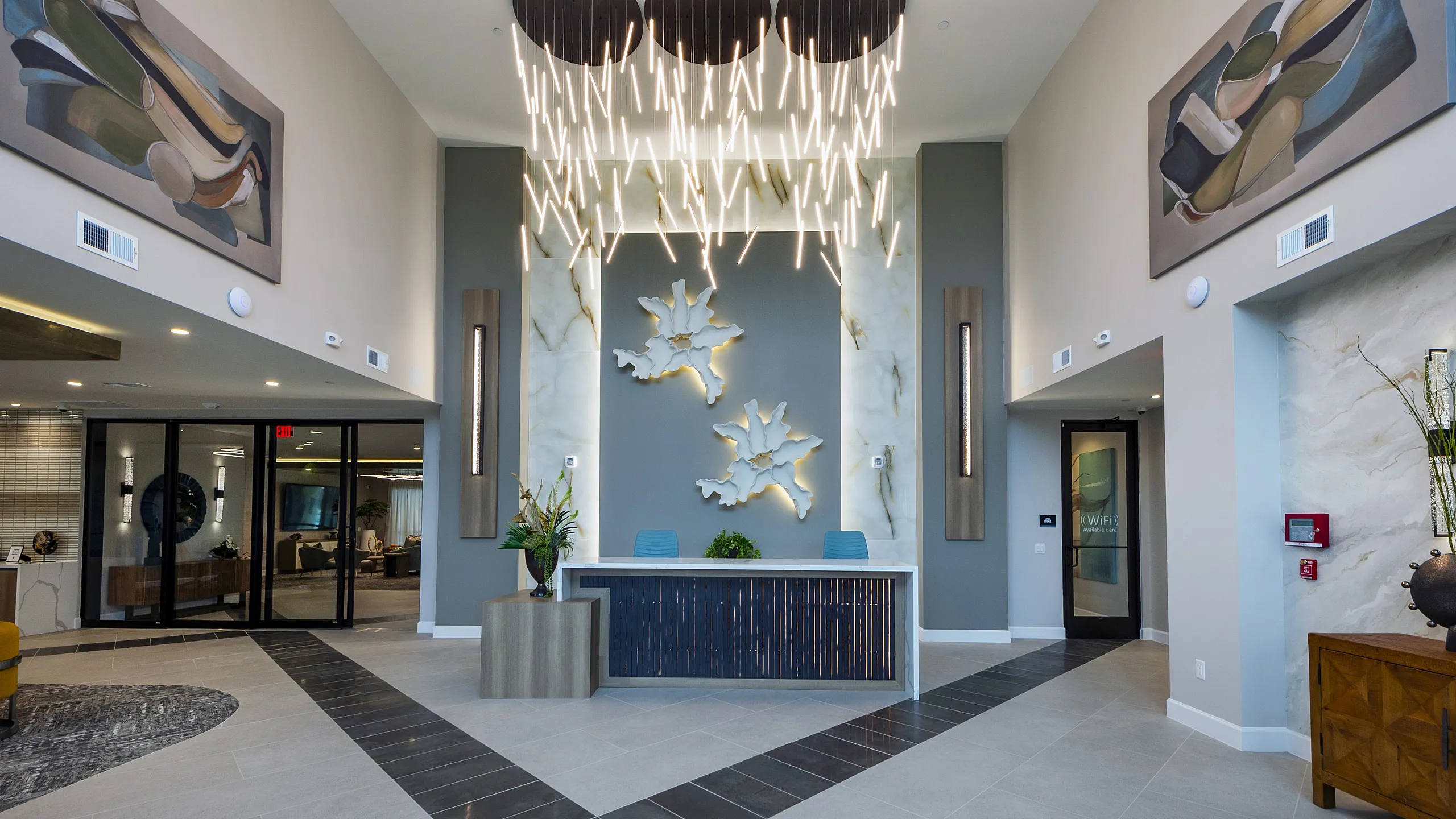 Luxurious lobby with striking modern chandelier, elegant decor, and welcoming reception area.