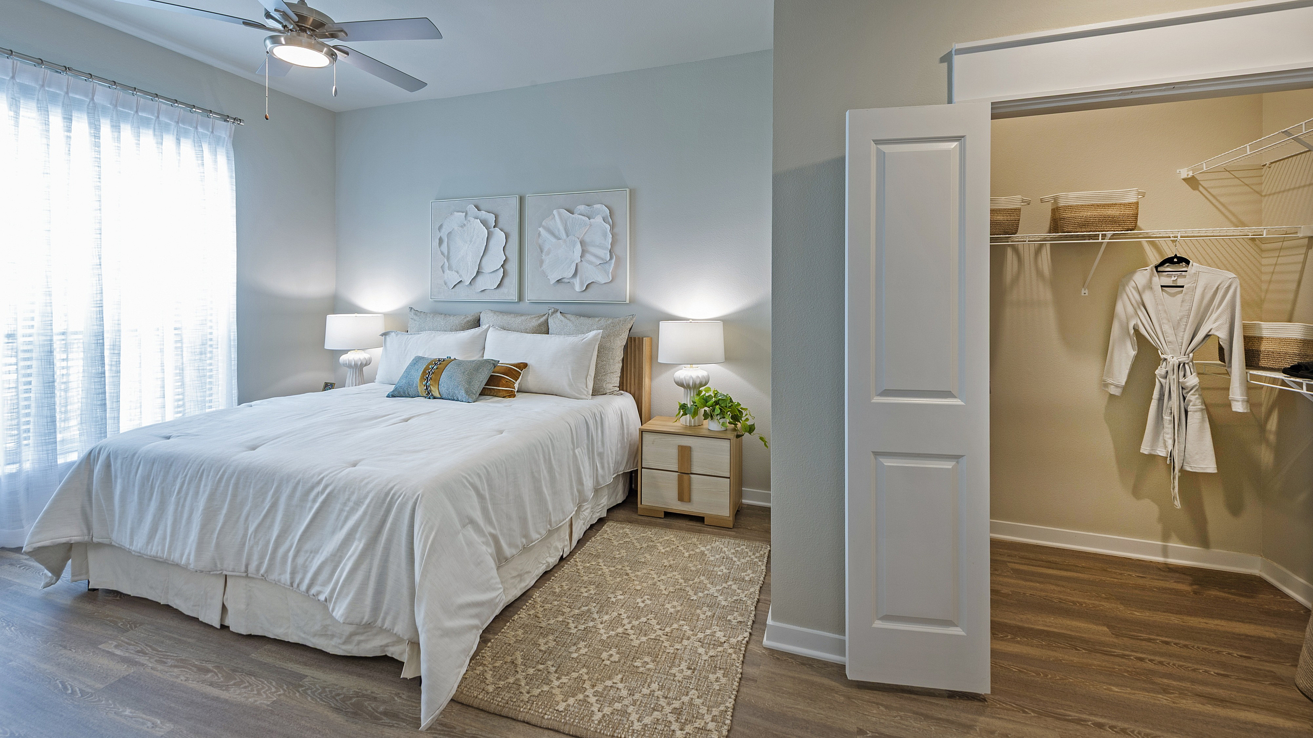 Elegant bedroom with cozy double bed, stylish artwork, and spacious walk-in closet for modern living.