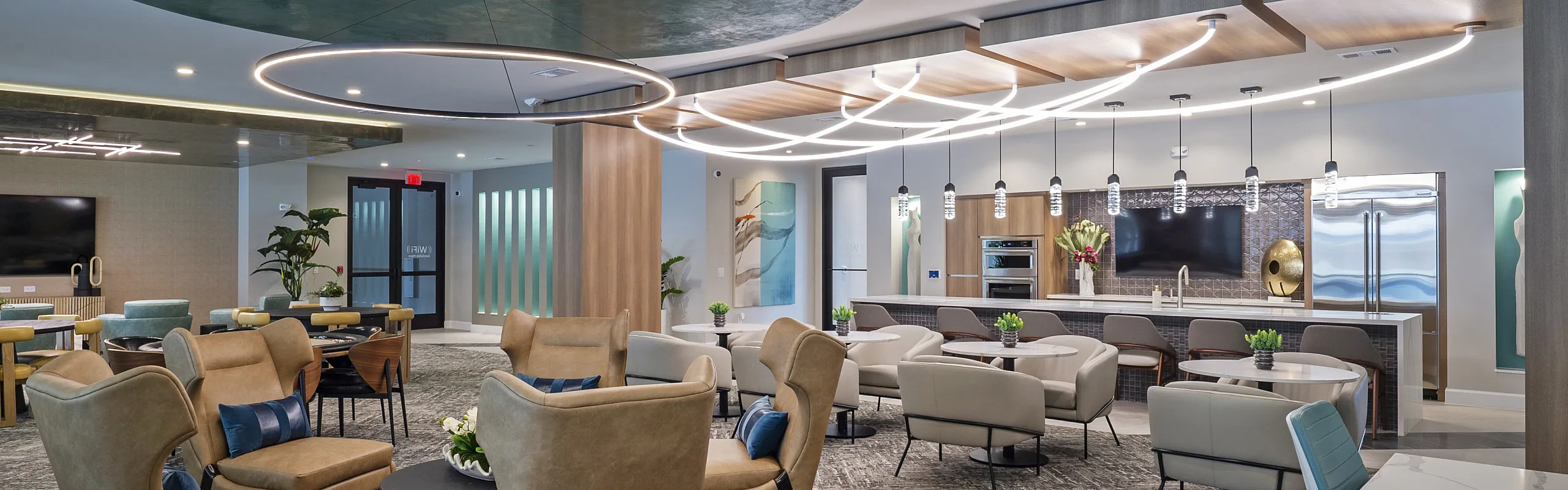 Elegant modern lounge with stylish seating, contemporary lighting, and a chic open kitchen perfect for social gatherings.
