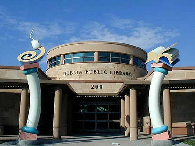 Dublin Public Library entrance featuring unique artistic columns and a modern architectural design against a clear blue sky.