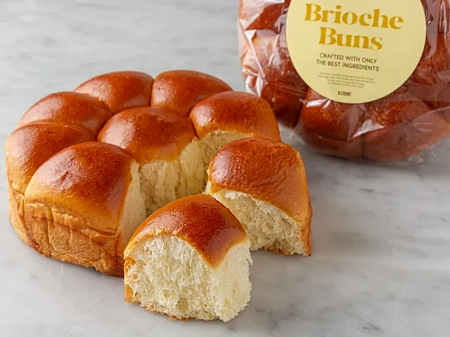 Tempting pack of Porto's Brioche Buns showcasing golden, soft texture, perfect for gourmet sandwiches.